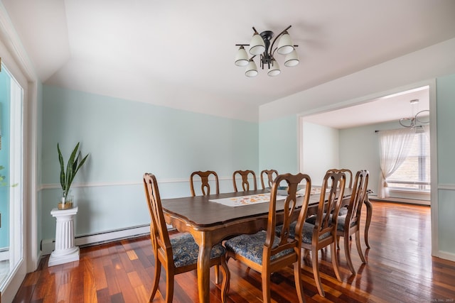 dining room with wood-type flooring, a baseboard radiator, and lofted ceiling