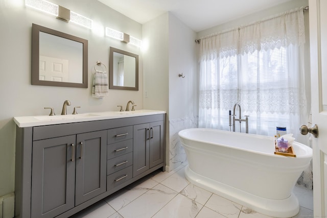 bathroom with vanity and a tub