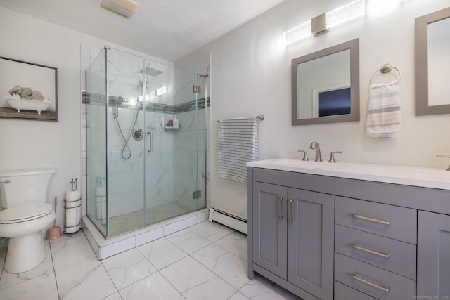 bathroom with vanity, toilet, a shower with shower door, and a baseboard heating unit