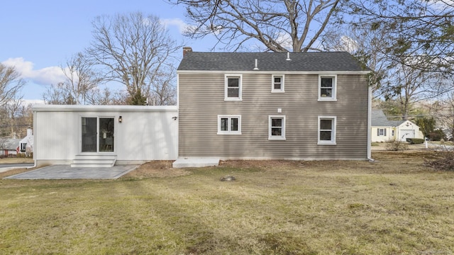 back of property featuring a patio area and a lawn