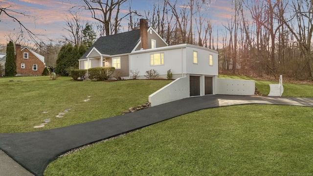 view of front facade featuring a lawn and a garage