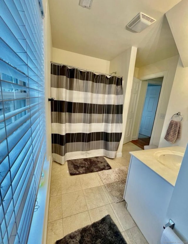 bathroom featuring tile patterned flooring and vanity