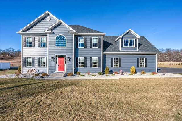 colonial inspired home with a front lawn