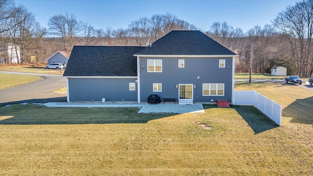 rear view of property with a lawn and a patio area