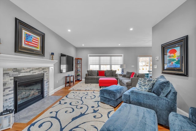 living room featuring a fireplace and light hardwood / wood-style flooring