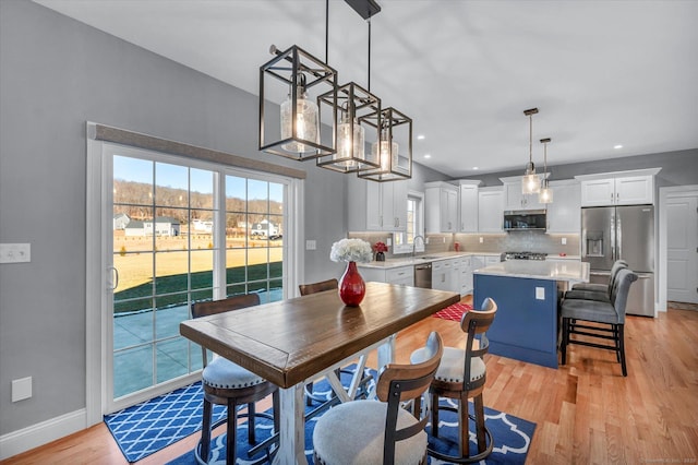 dining area with light hardwood / wood-style floors and sink