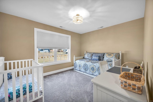 bedroom with an inviting chandelier and carpet