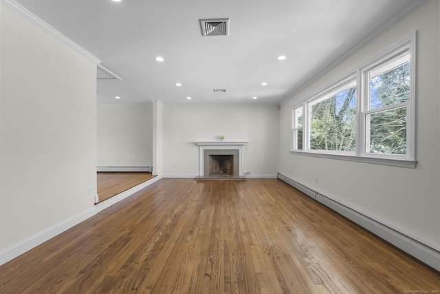 unfurnished living room featuring visible vents, a fireplace, crown molding, and a baseboard radiator