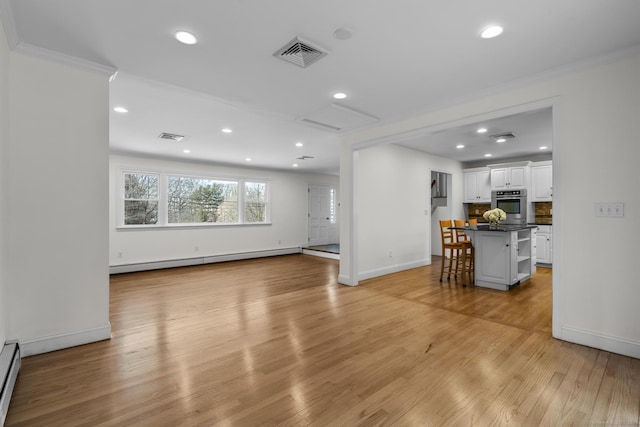 living room with recessed lighting, a baseboard radiator, light wood-style floors, and visible vents