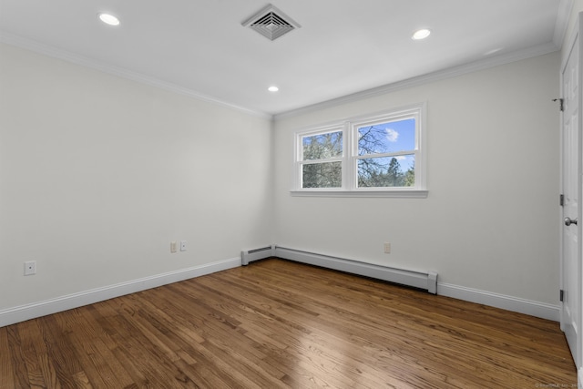 empty room with visible vents, ornamental molding, wood finished floors, baseboards, and baseboard heating