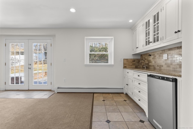 kitchen with white cabinets, light tile patterned floors, tasteful backsplash, and baseboard heating