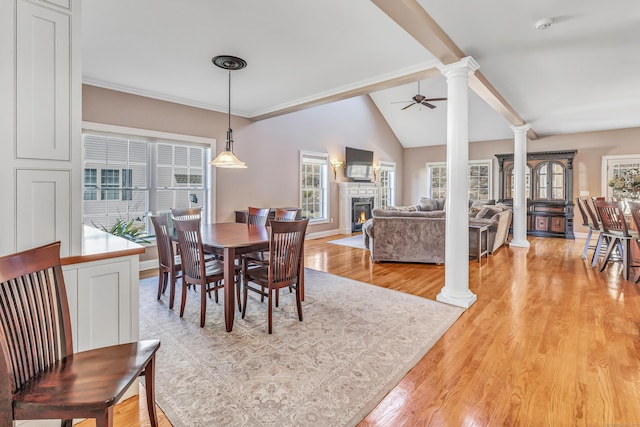 dining room with ceiling fan, light wood-type flooring, a wealth of natural light, and lofted ceiling