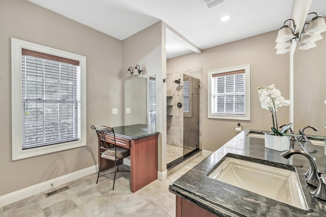 bathroom with walk in shower, vanity, and a wealth of natural light