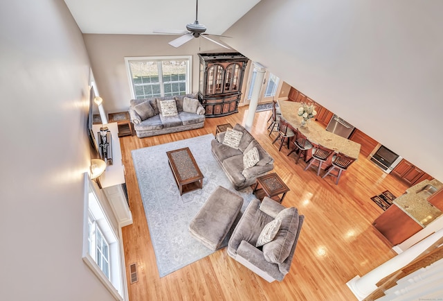 living room with hardwood / wood-style floors and ceiling fan