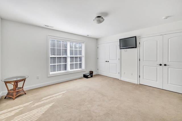 bedroom with light colored carpet