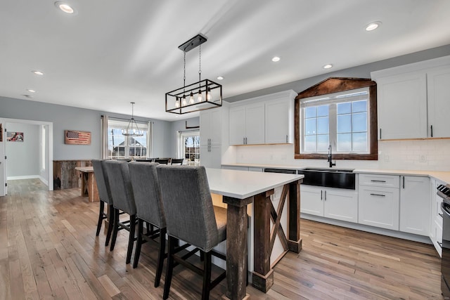 kitchen with a center island, white cabinetry, and sink