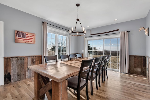 dining room with light hardwood / wood-style floors, an inviting chandelier, and a wealth of natural light