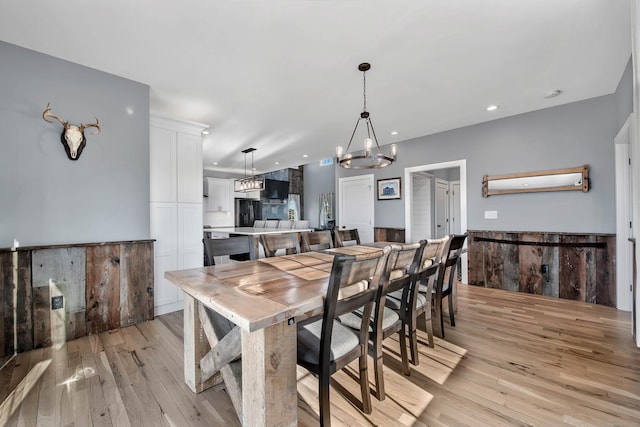 dining room featuring light hardwood / wood-style floors and a chandelier