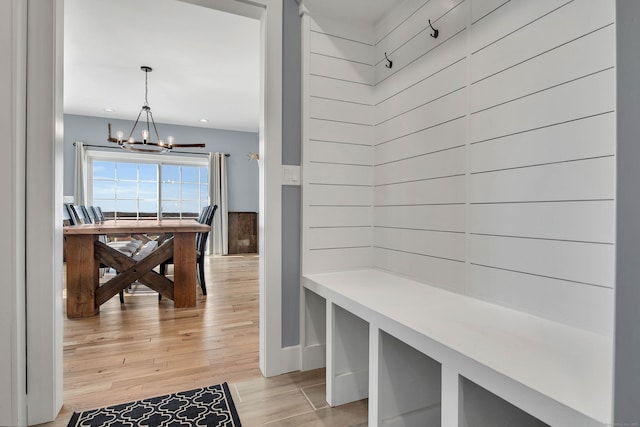 mudroom featuring light hardwood / wood-style floors and an inviting chandelier