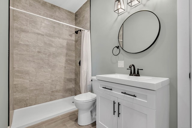 bathroom featuring vanity, toilet, and walk in shower