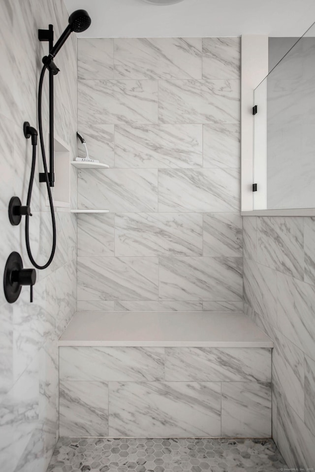 bathroom with a tile shower