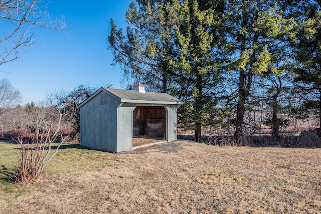 view of outbuilding with a yard