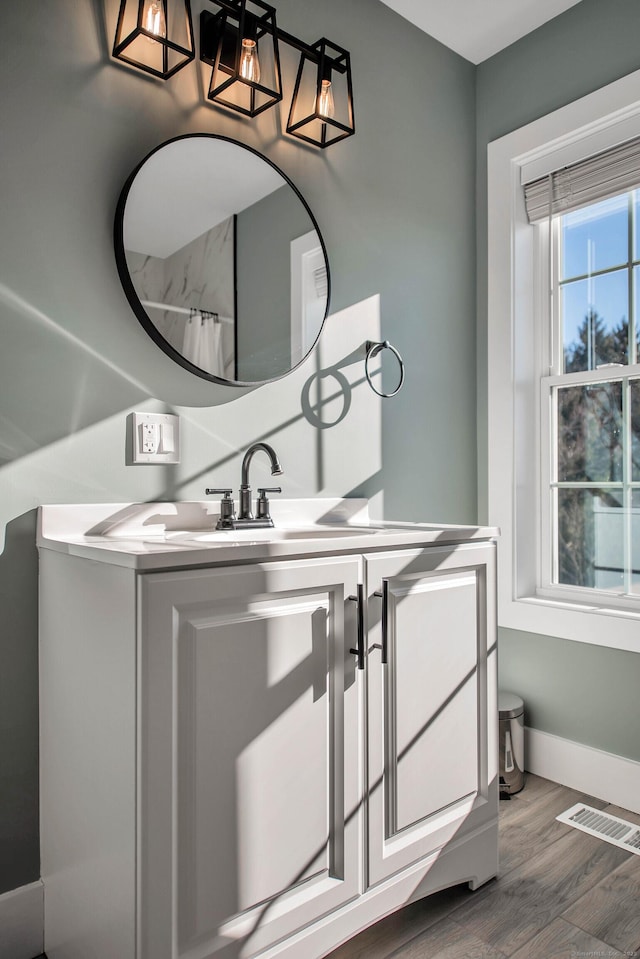 bathroom featuring a shower with shower curtain, wood-type flooring, and vanity