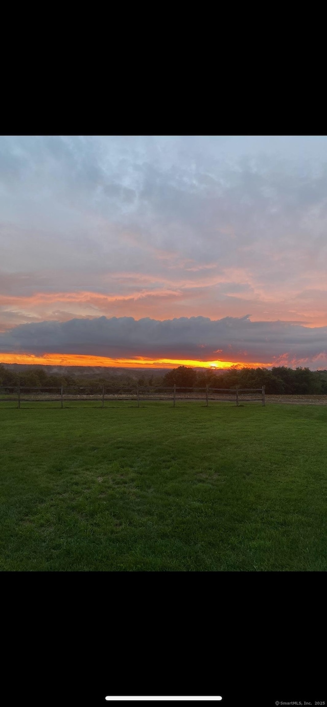 yard at dusk with a rural view