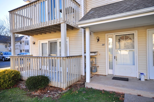 doorway to property with a balcony and covered porch