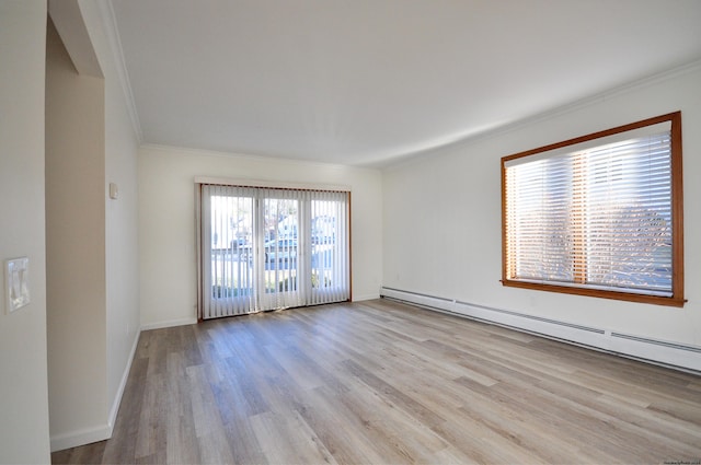 unfurnished room with a baseboard heating unit, light wood-type flooring, and crown molding