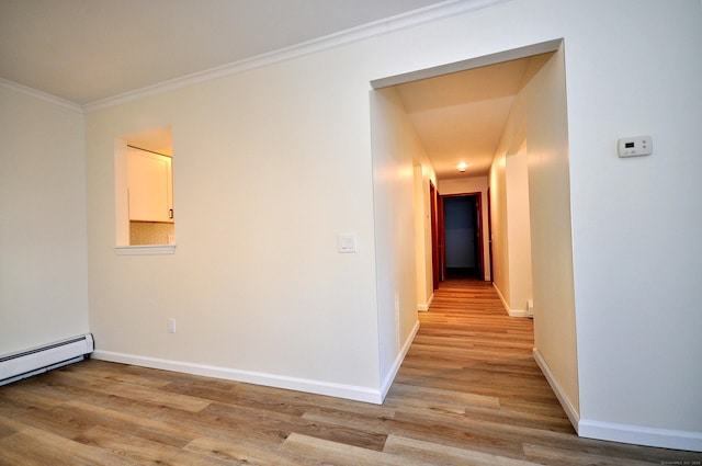 hall featuring baseboard heating, light hardwood / wood-style floors, and crown molding