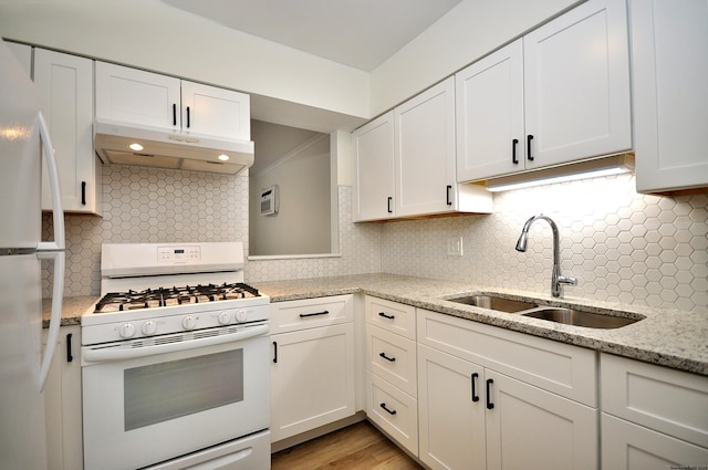 kitchen featuring sink, white appliances, backsplash, and white cabinets