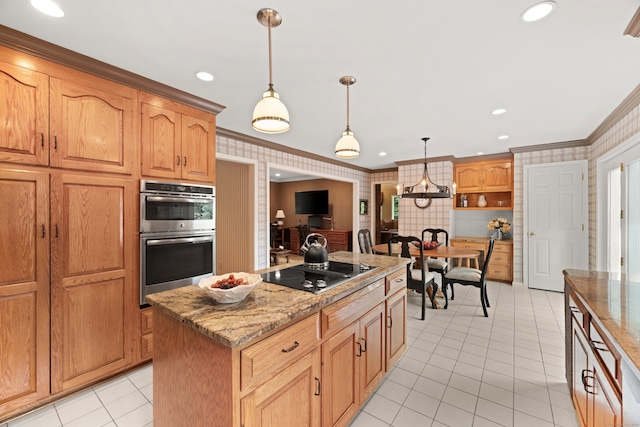 kitchen with black electric stovetop, ornamental molding, decorative light fixtures, a kitchen island, and stainless steel double oven