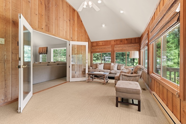 sunroom with french doors, vaulted ceiling, ceiling fan, and a baseboard heating unit