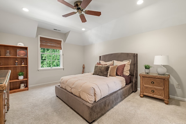 bedroom featuring light colored carpet, vaulted ceiling, and ceiling fan