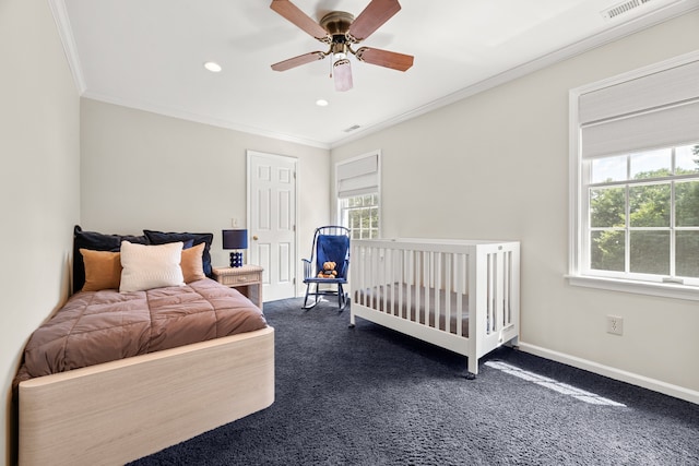 carpeted bedroom featuring ceiling fan and crown molding