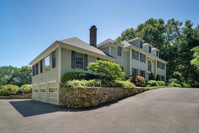 view of property exterior featuring a garage