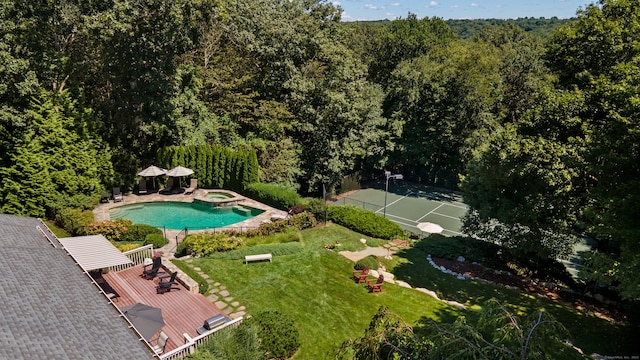 view of pool with a yard and a deck