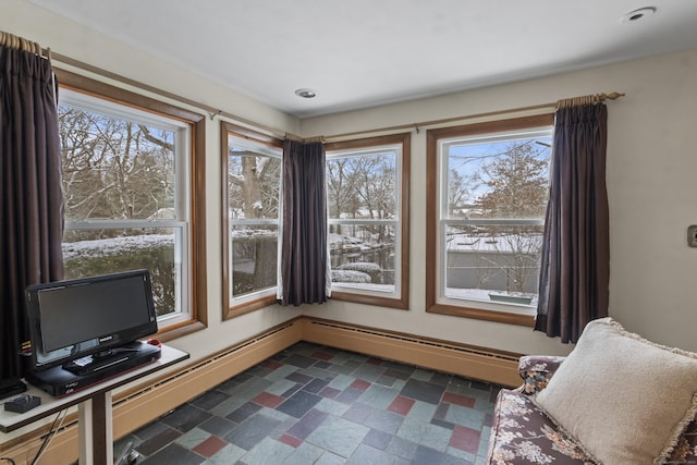 living area with a baseboard heating unit