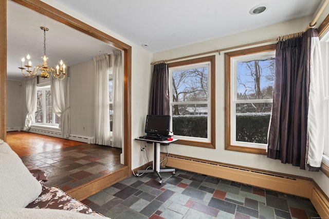 foyer featuring baseboard heating, plenty of natural light, and a notable chandelier