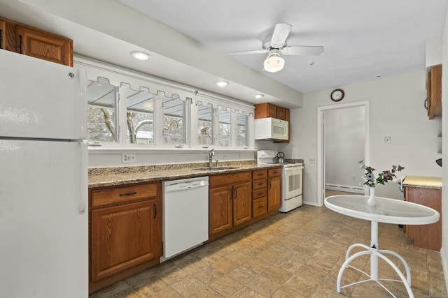 kitchen with a wealth of natural light, sink, ceiling fan, and white appliances