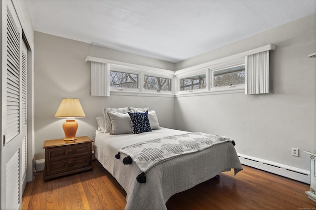 bedroom featuring hardwood / wood-style floors, a closet, and a baseboard radiator