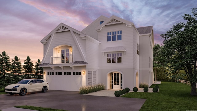 view of front facade with concrete driveway, a front lawn, an attached garage, and a balcony