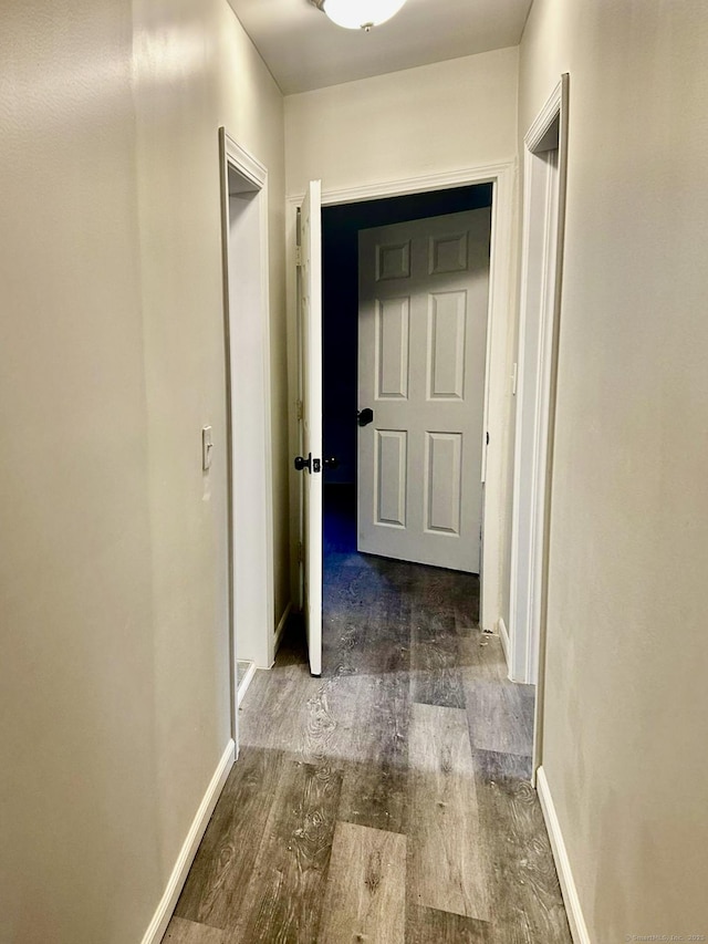 hallway with dark wood-type flooring