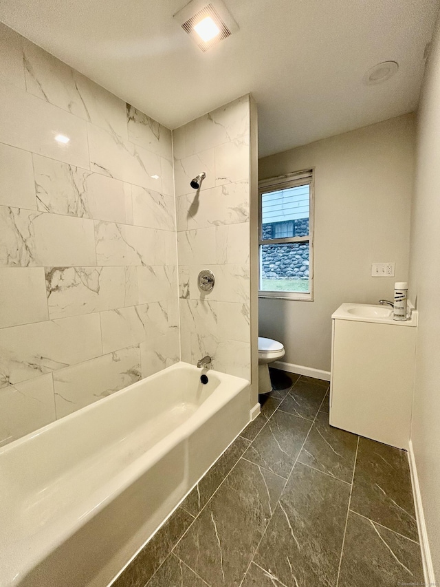 full bathroom with vanity, toilet, and tiled shower / bath