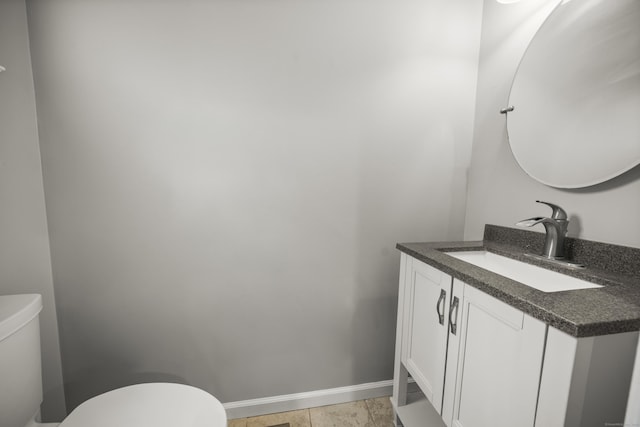 bathroom featuring tile patterned flooring, vanity, and toilet