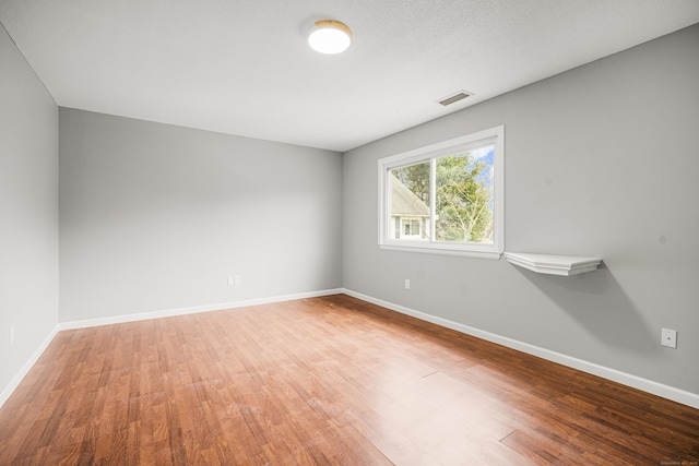 spare room with wood-type flooring