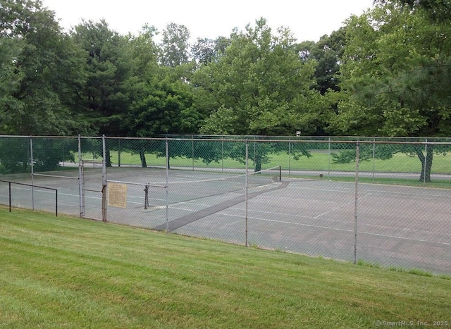 view of sport court featuring a lawn