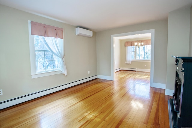 unfurnished living room with a wall mounted air conditioner, a chandelier, wood-type flooring, and a baseboard radiator