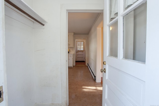 hallway featuring a baseboard radiator and ornamental molding